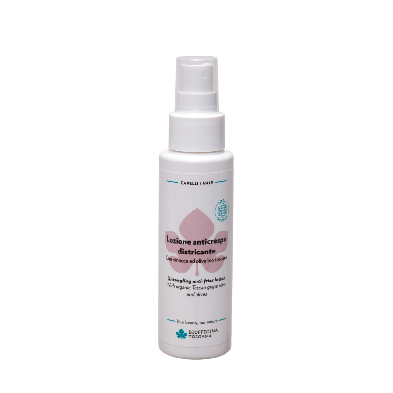 A white plastic spray bottle of Biofficina Toscana hair care product, featuring a white pump dispenser and a label with pink and teal accents. Lightweight but powerfully frizz-fighting spray for unruly hair.