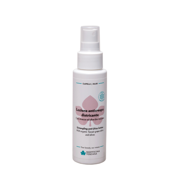 A white plastic spray bottle of Biofficina Toscana hair care product, featuring a white pump dispenser and a label with pink and teal accents. Lightweight but powerfully frizz-fighting spray for unruly hair.