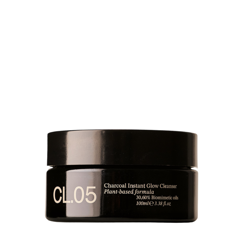 A black cosmetic jar of CL.05 Charcoal Instant Glow Cleanser with gold text, set against a plain white background.