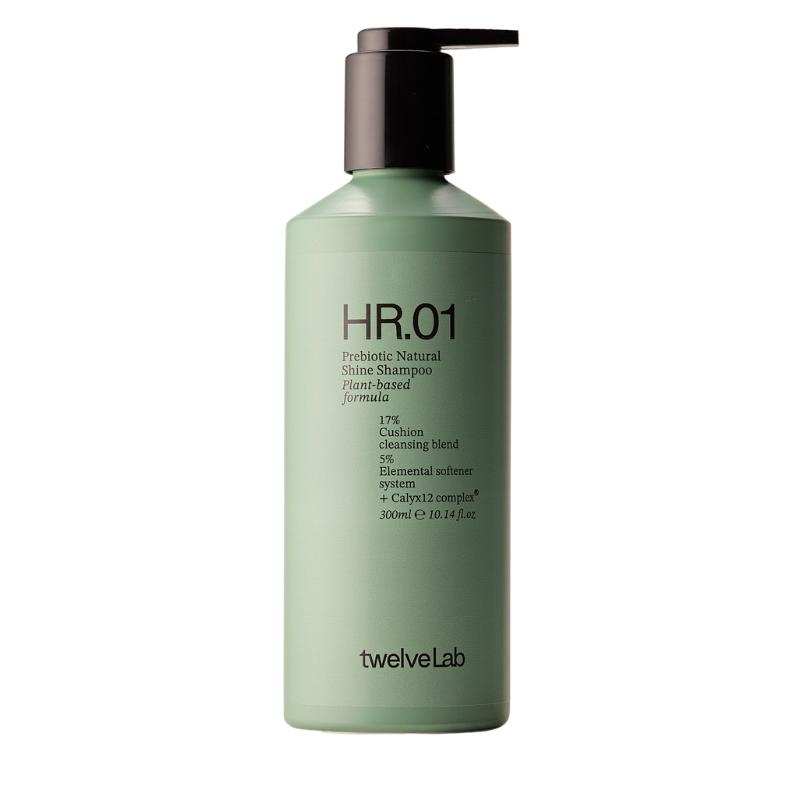 A 500ml bottle of twelveLab HR.01 Probiotic Natural Shine Shampoo, featuring a light sage green bottle and a dark brown pump dispenser, set against a plain white background.